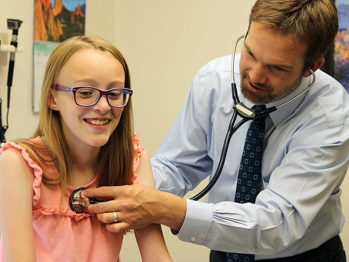 Youg patient with a physician at the Allergy and Asthma Center of Western Colorado in Grand Junction, Colorado.